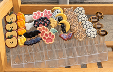 Load image into Gallery viewer, Ceramic paperclip bookmarks in apple, pencil, dog bone, paw print, moon, ghost, bat, butterfly, tiger, soccer ball and football designs.