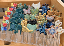 Load image into Gallery viewer, Ceramic paperclip bookmarks in elephant, LOVE, cactus, butterfly, cat, turtle, star, pumpkin and artist palette designs.
